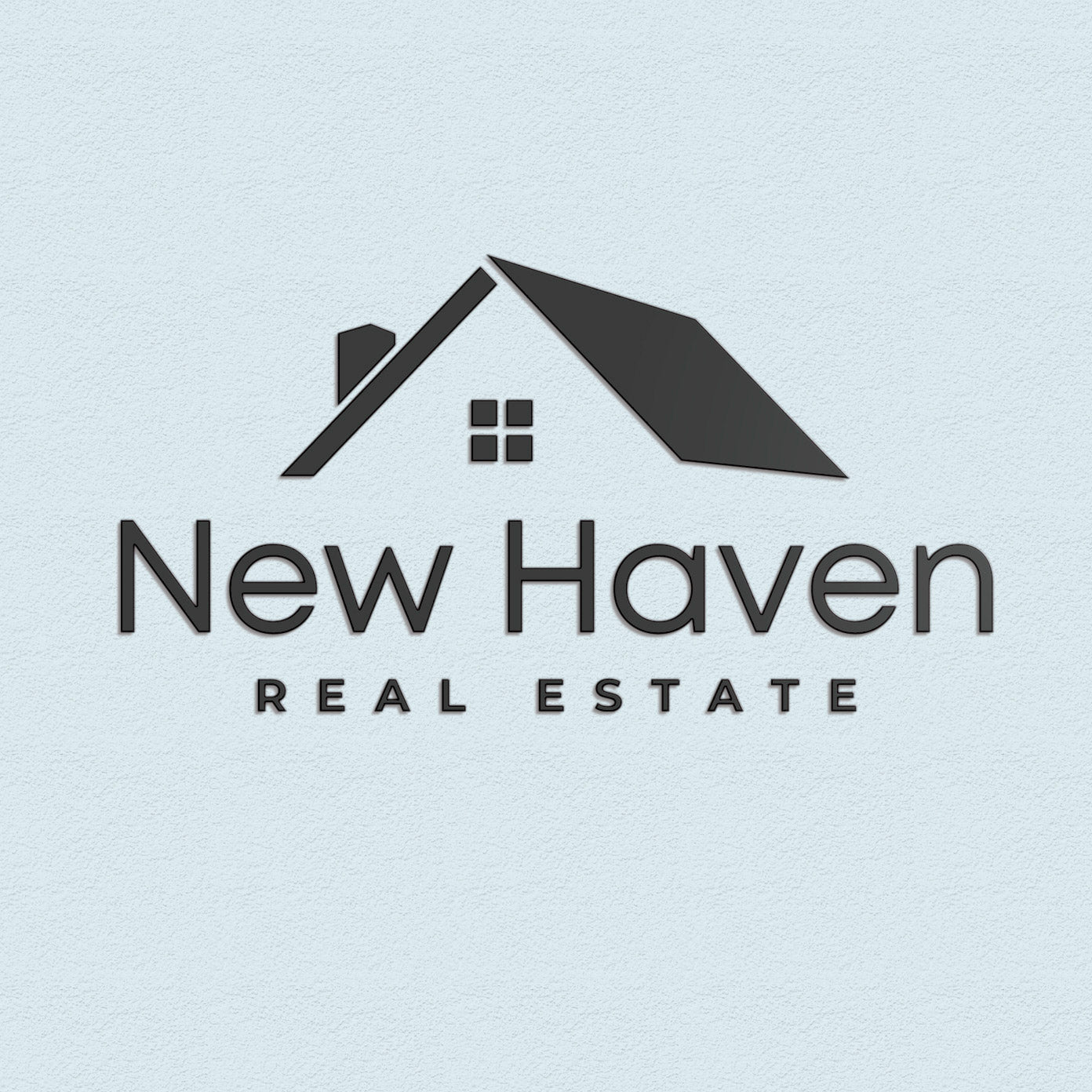 New Haven Real Estate matte black lobby logo with a house icon on a light blue wall.